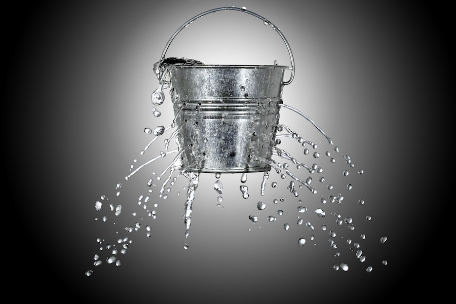 bucket with holes and water spilling out
