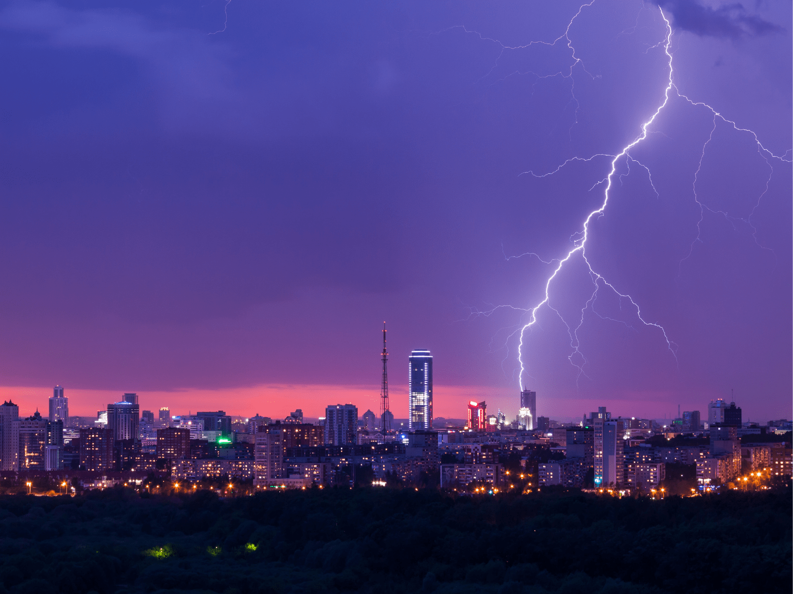 city skyline with lightning striking a high rise building
